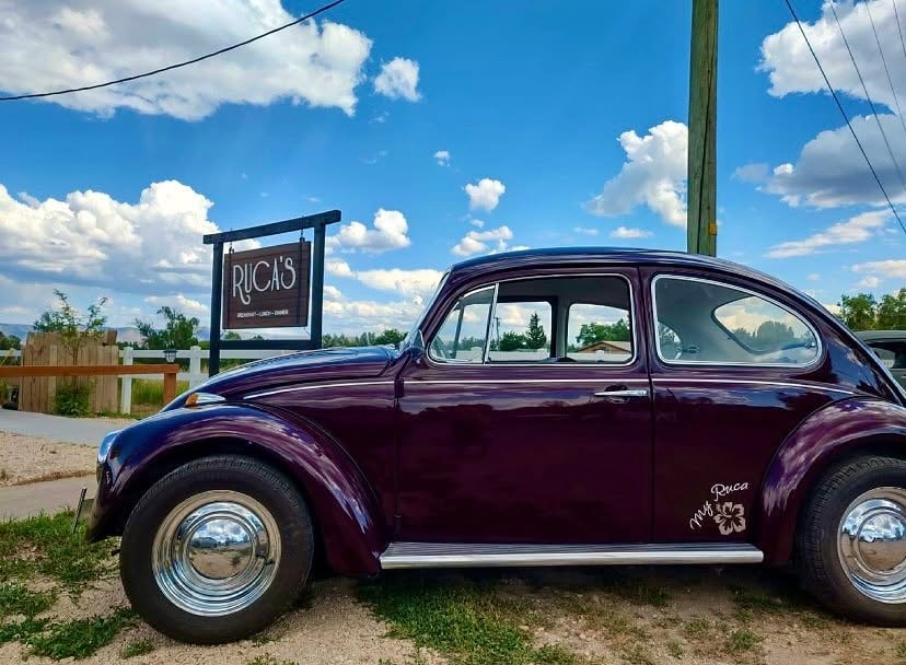 My Ruca Bug — the 1969 VW Beetle that inspired the restaurant's name, parked in front of the Ruca's sign